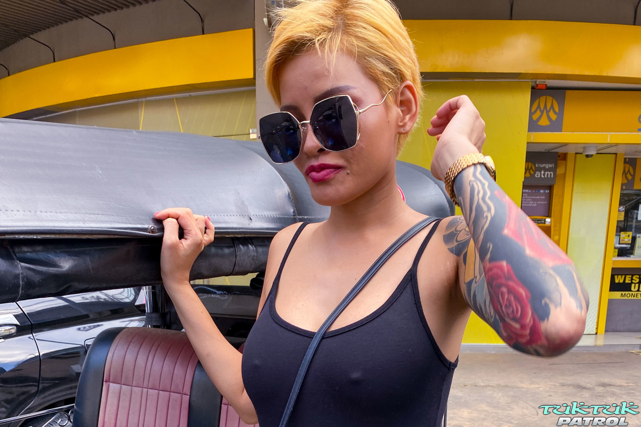 Exotic Thai girl Susy shows off her tattooed body and big tits before having fun with it.