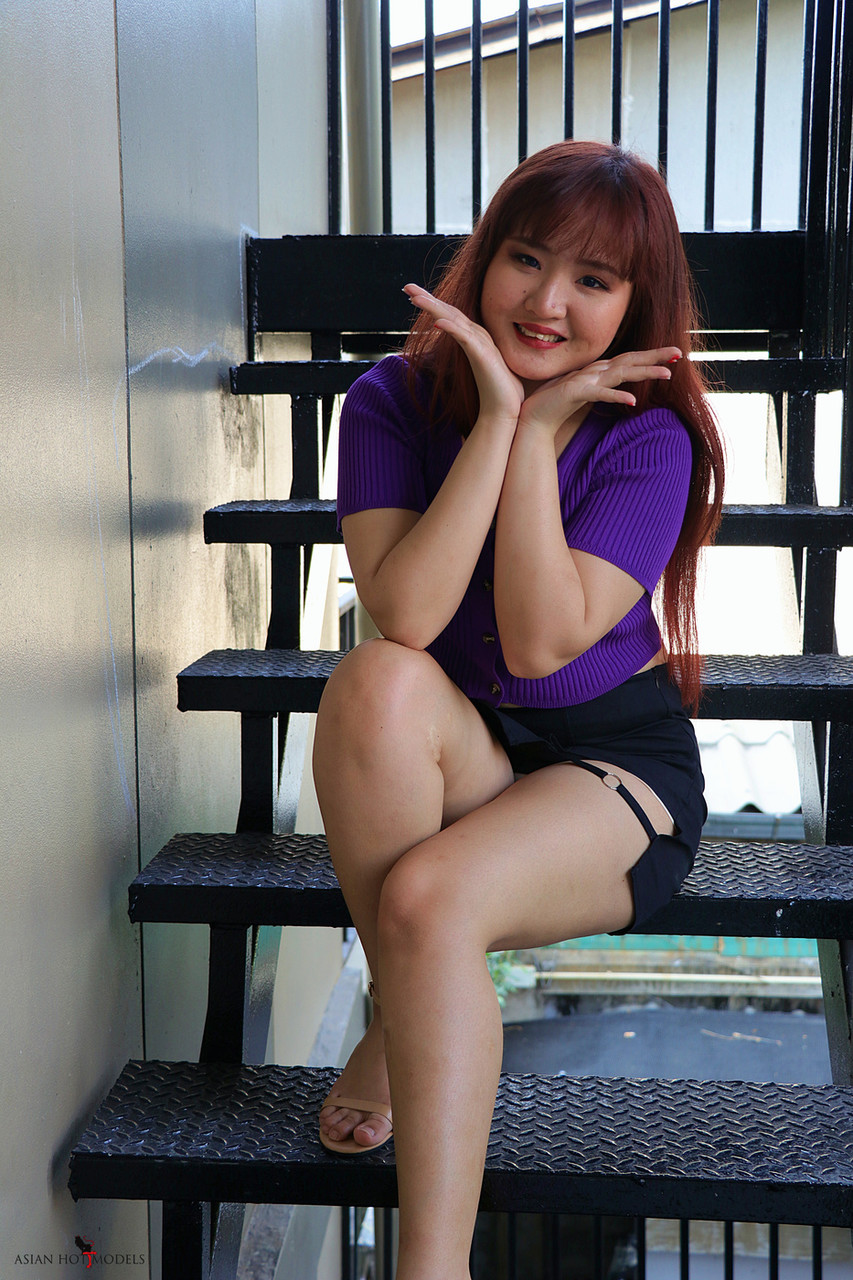 Redheaded Asian Beauty Poses On The Stairs In Her Hot Skirt Purple Top