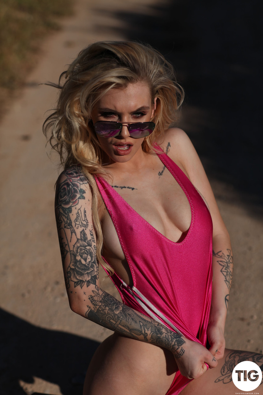 Model with tattoos Saskia Valentine peels off her bodysuit and poses outdoors porn photo #425651824