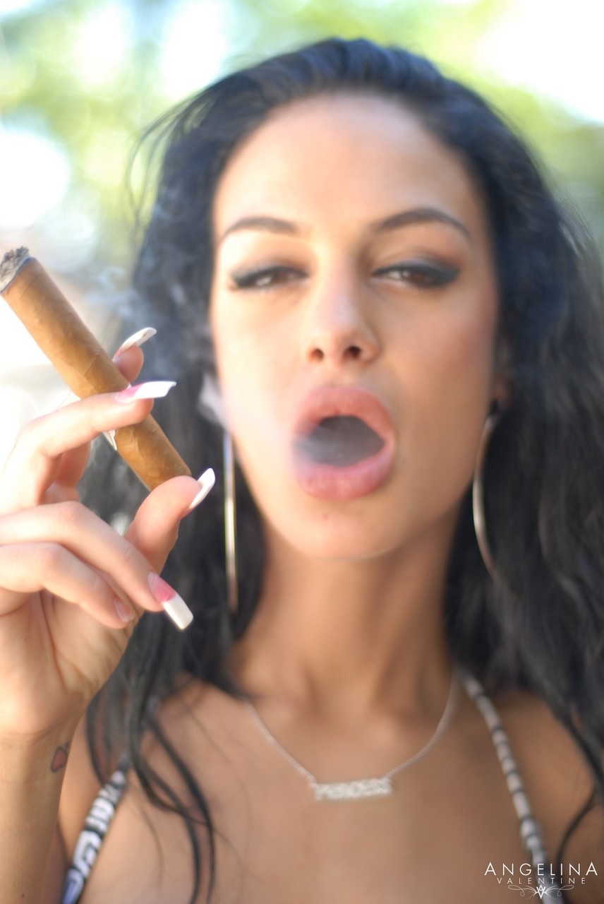 Hot brunette pornstar Angelina Valentine smokes a cigar with her fake tits out porn photo #426502593