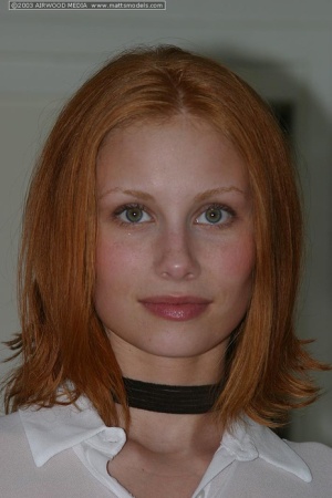 Pale redhead Anya poses naked on kitchen counter in a black choker