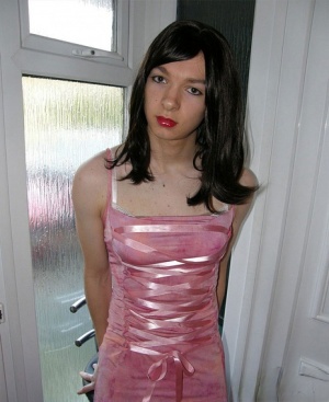 Petite TGirl showing off that slender body of hers in a pink dress