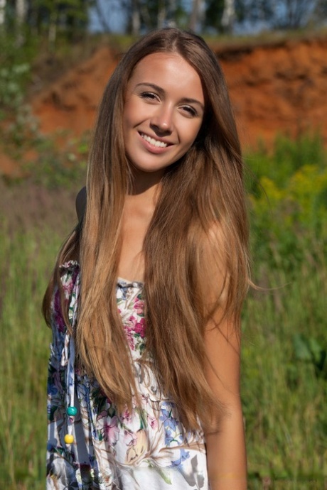 Exhibits: Long-haired Lina strips out of her colorful dress outside.