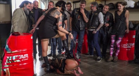 Prior to being gangbanged, a submissive girl is publicly humiliated.