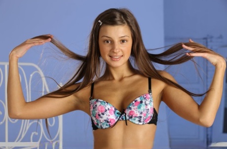 Charming: Teen goddess Melena A frees herself from the bra and panty ensemble.