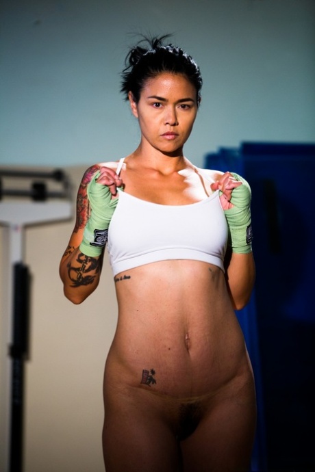 The tattooed Asian woman Dana Vespoli displays her tight ass during a weigh-in.
