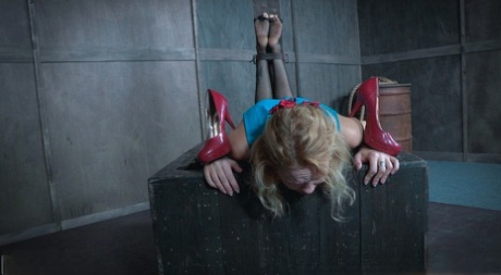 While held captive in a dungeon hole, the blonde woman Rain Degrey is completely humiliated.