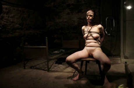 Armed men torture Nadja, the brunette who is tied up with electrical devices.