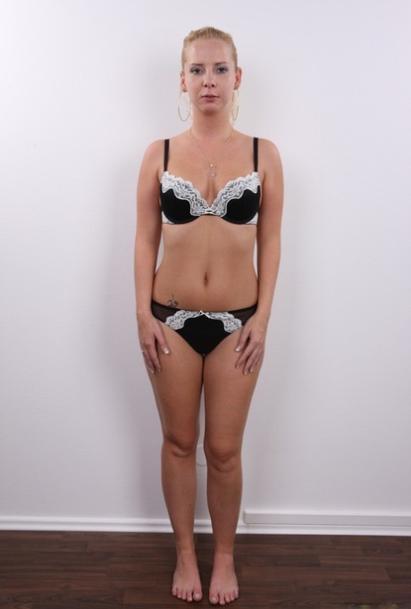 Amateur model Lucie uncups firm tits before removing a thong to stand naked