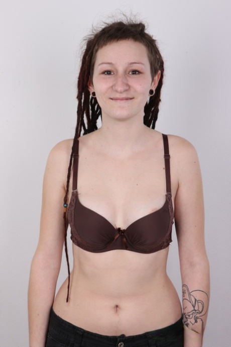 The amateur girl with dreadlocks disrobes and displays her landing strip pussy.