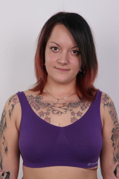 With a tattoo on her body, Vendula, an amateur tattoo artist, removes her clothing from her chubby frame.
