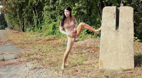 Dark haired girl Lady Dee wanders off the side off a road to take a pee