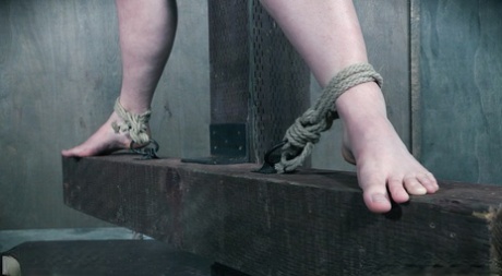 Dwarfing down, a fat white girl named Phoenix Rose is tied up with rope in one of the dungeons.