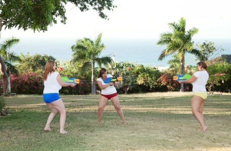 Water fight: Thick women flaunt giant boobs as they swim.