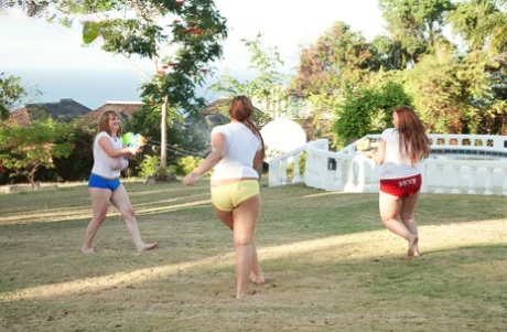 In a water fight, thin women expose their massive breasts.