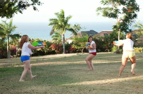 When participating in a water fight, thin women expose their massive breasts.