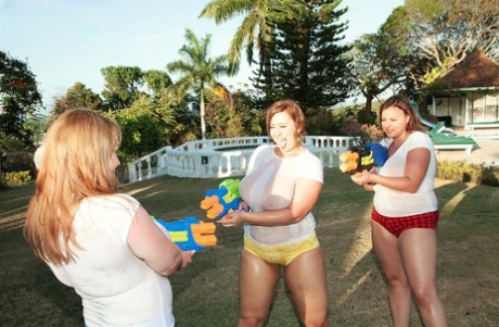 Water fight: Thin women expose their huge breasts.