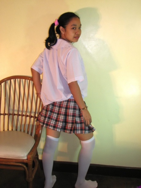 Asian Schoolgirl Maryjane Shows Her Bald Cunt On A Chair In OTK Socks