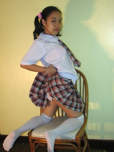Asian Schoolgirl Maryjane Shows Her Bald Cunt On A Chair In OTK Socks