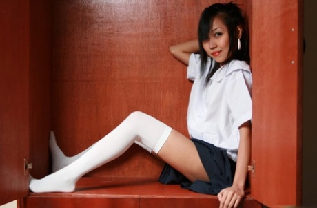 White thigh highs are worn by an Asian schoolgirl who then shows off her tight hemmed eyes.