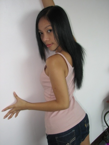 Skinny Asian girl reveals her teensy titties and petite ass on her knees