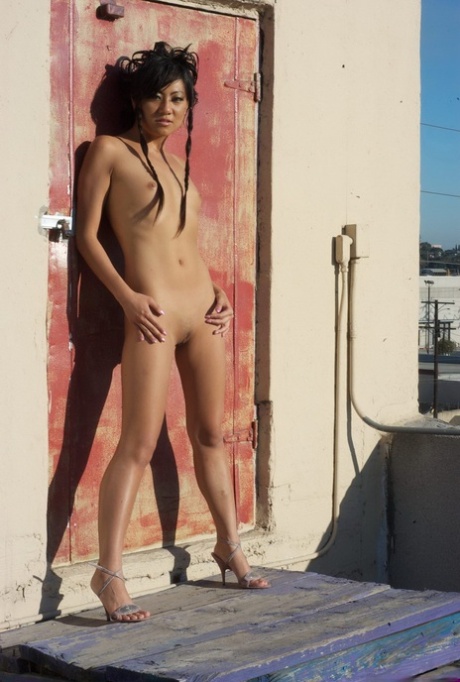 Asian Model Strikes Hot Nude Poses On The Rooftop Of Building In The City