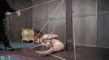 Acts of humiliation: Naked redhead Lauren Phillips is subjected to bondage.
