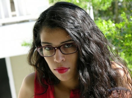 Dark-haired girl with red lips, Lucinda makes her nude first appearance with glasses.