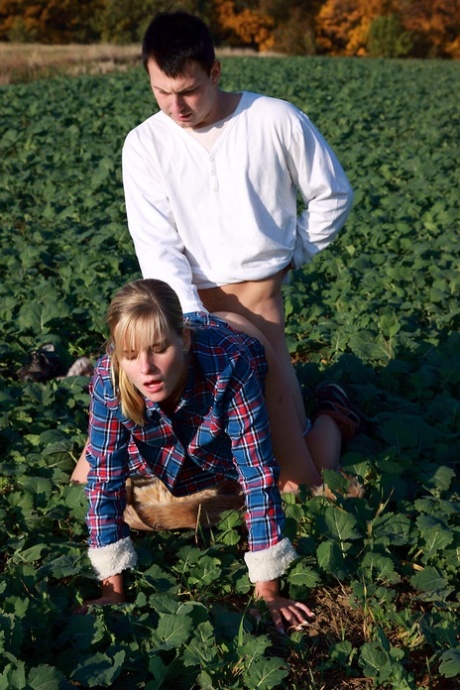 The girl and her boyfriend have sex outside in the privacy of an open field.