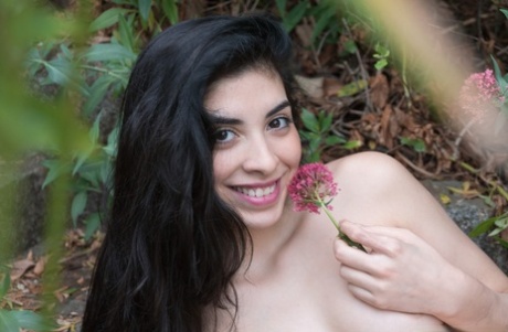 In the garden, Ornella is seen kissing and embracing the flowers on her hairy twank.