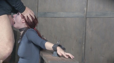 The face of pale redhead Violet Monroe is subjected to brutal fucking in the depths of dungeons.