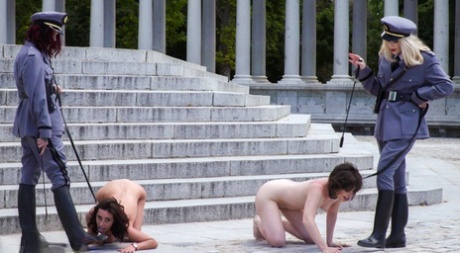 A group of female military members humiliate naked girls in front of a gangbane.