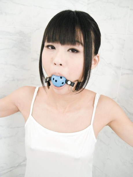 As she receives cuntlets, Japanese girl Chika Ishihara is ball gagged and bound.