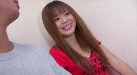 Phallus head is taken care of by Noriko Kago, an Asian doll wearing a red T shirt.