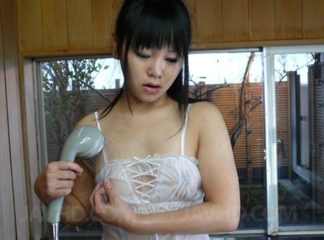 Adorable Japanese girl: Koyuki Ono (left) masturbates in a bathtub while wearing white lingerie.