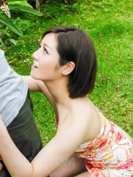 Japanese Woman Minami Asano Bares Her Small Tits While Giving A BJ In A Garden