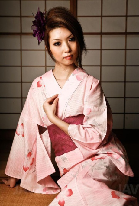Rinka Kanzaki, who is a Japanese girl engaged in MMF sexual activity, removes her clothing from her kimono during the act.