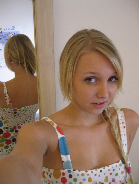 The first-time blond girl shows her facial features in the mirror, including her twats and breasts, as she prepares for self-defense.