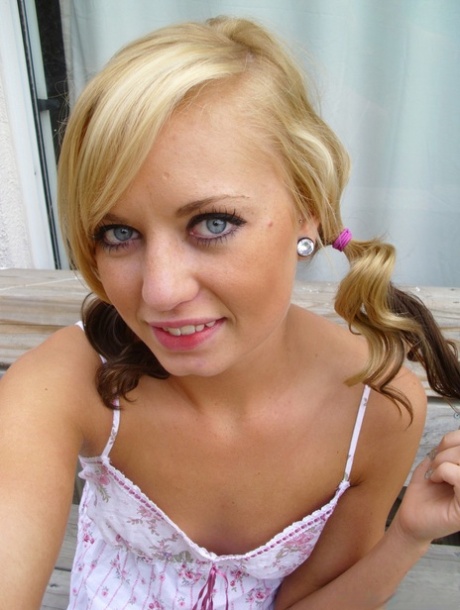 In pigtails, an adorable blonde Tiff displays her tiny toe-like feet with long hair and small tits. She also has a small bald pussy.