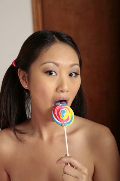Asian Girl Evelin Wears Her Hair In Pigtails While Sucking A Lollipop And Cock