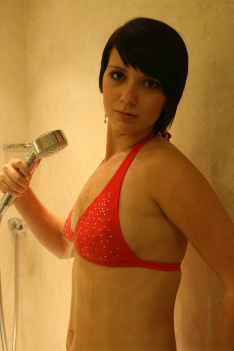 First timer Miss Kelly lets her breasts escape from a bikini top while taking a shower.