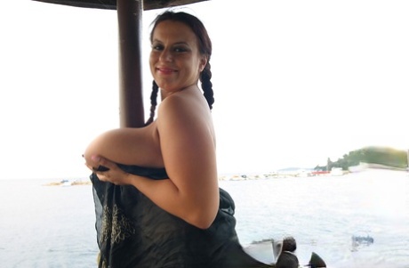 Women with big breasts, Kora Kryk and Aneta Buena, pose with their oversized chests for a passing boat.