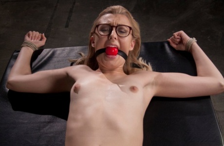 Slim blonde Alexa Grace is forcefully masturbated while ball gagged in glasses