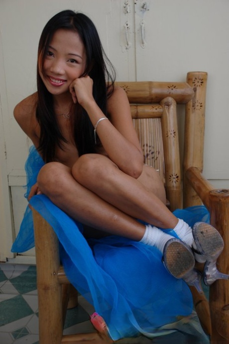 A skinny Filipina girl poses in bare clothes while wearing white socks.