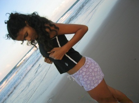 At the beach, Polliana, a Brazilian girl who is not overweight, pulls up her swimsuit.