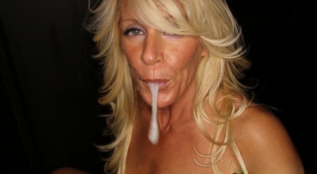 Young MILF Gina suckling with an edible cum bite after receiving lip-locking.