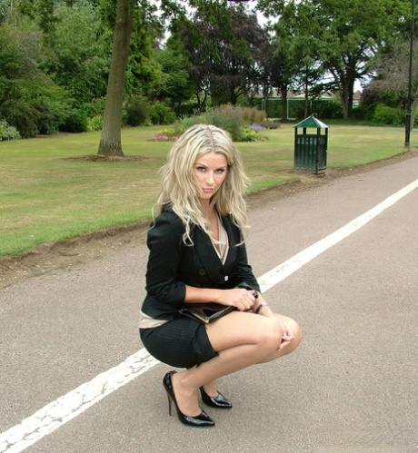 Clothed Blonde Secretary Shows Off Her Legs And Pumps In A Public Park