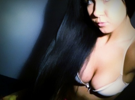 A woman with long black hair and is an amateur, Sabrina Sins takes nude selfies.