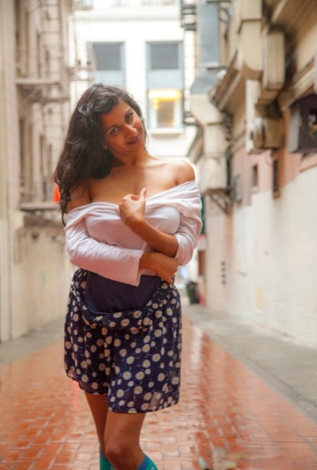 Near the mall's alley, Carla White from India walks with her big natural tits.
