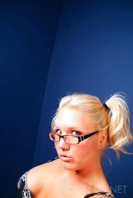 Kay, the charming blonde, sews up her glasses with a thong.
